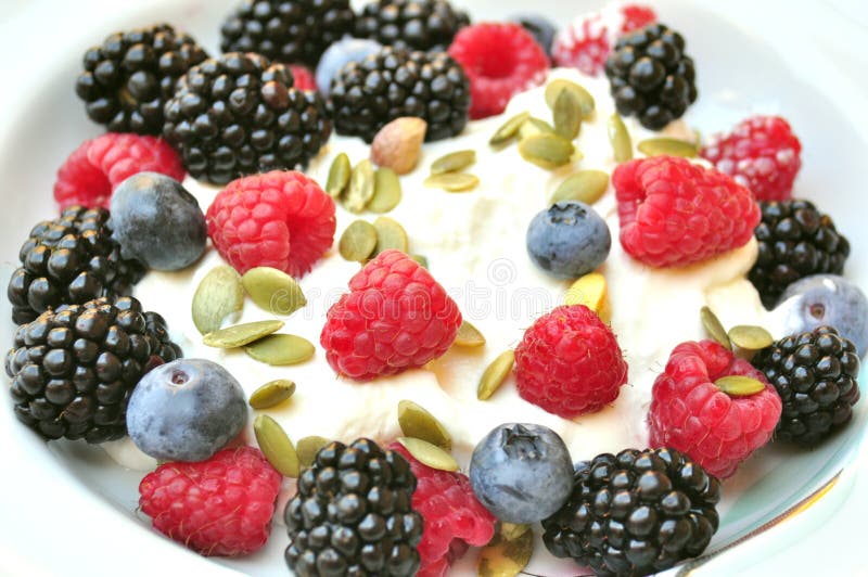 Healthy breakfast with blackberries , blueberries and raspberries