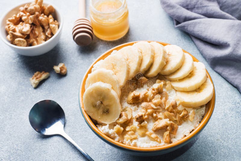 Healthy Breakfast. Cottage Cheese with Banana and Walnuts on Grey