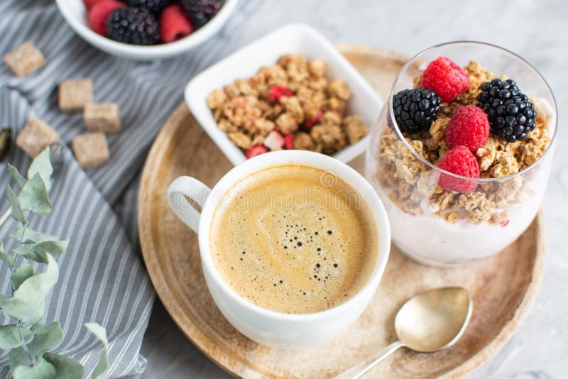 Healthy Breakfast Cup of Coffee Greek Yogurt with Homemade Granola, Berries, Raspberries and Blackberries Work Laptop