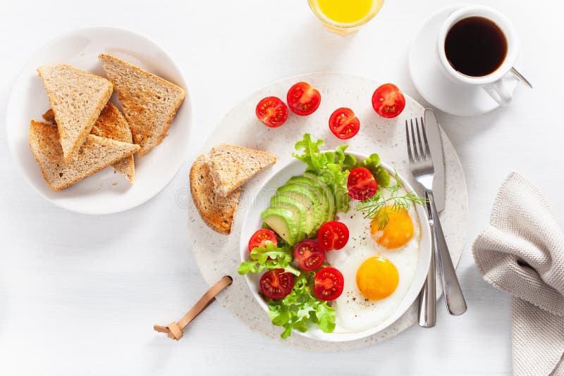 Healthy Breakfast Flat Lay. Fried Eggs, Avocado, Tomato, Toasts Stock