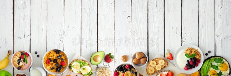 Healthy breakfast food banner with bottom border of fruits, yogurt, smoothie bowl, nutritious toasts, cereal and egg skillet, top stock photos