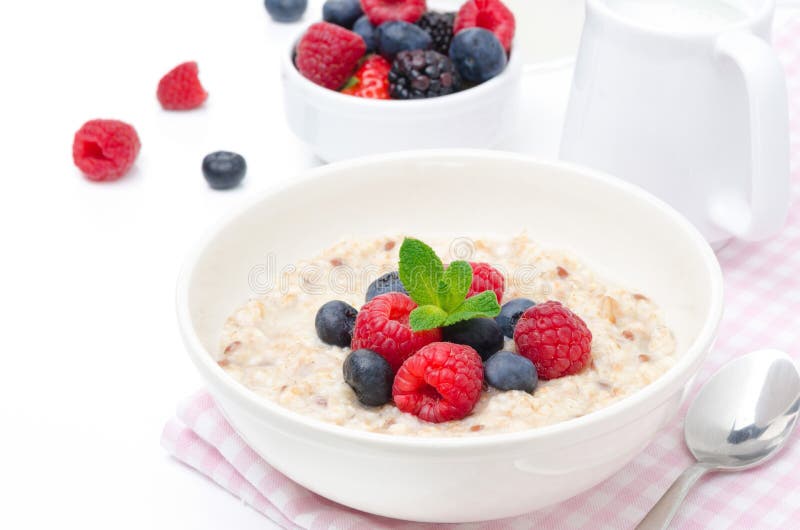 Healthy breakfast - oatmeal with fresh berries isolated on white