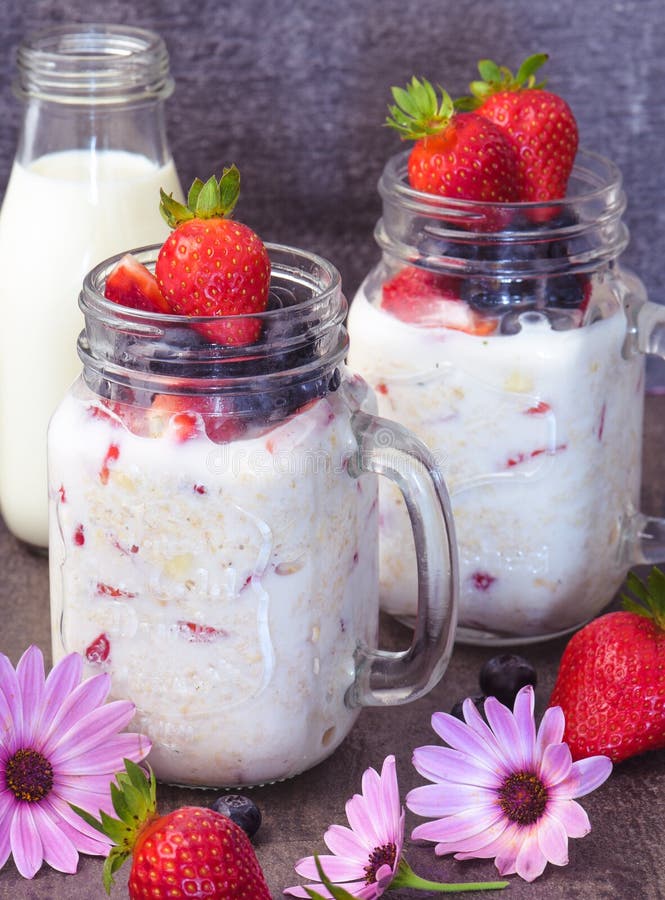 Healthy breakfast overnight oats with fresh berry in mason jar