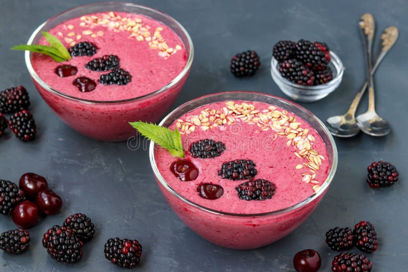 Healthy breakfast smoothie bowl with blackberries, cherries and oatmeal on dark background, horizontal photo stock photos Healthy breakfast smoothie bowl with blackberries, cherries and oatmeal on dark background, horizontal photo stock photos