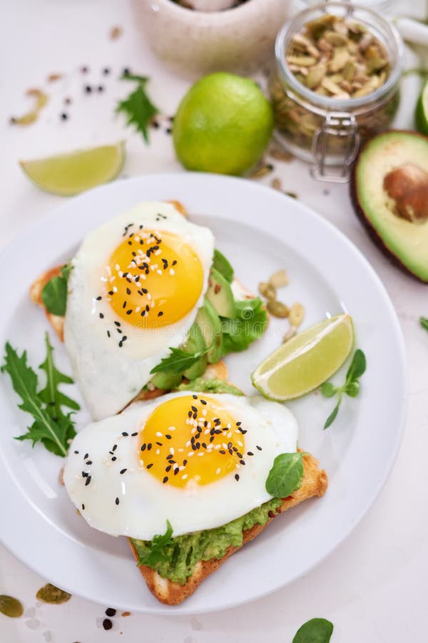 Healthy Breakfast or Snack - Sliced Avocado and Fried Egg on Toasted ...
