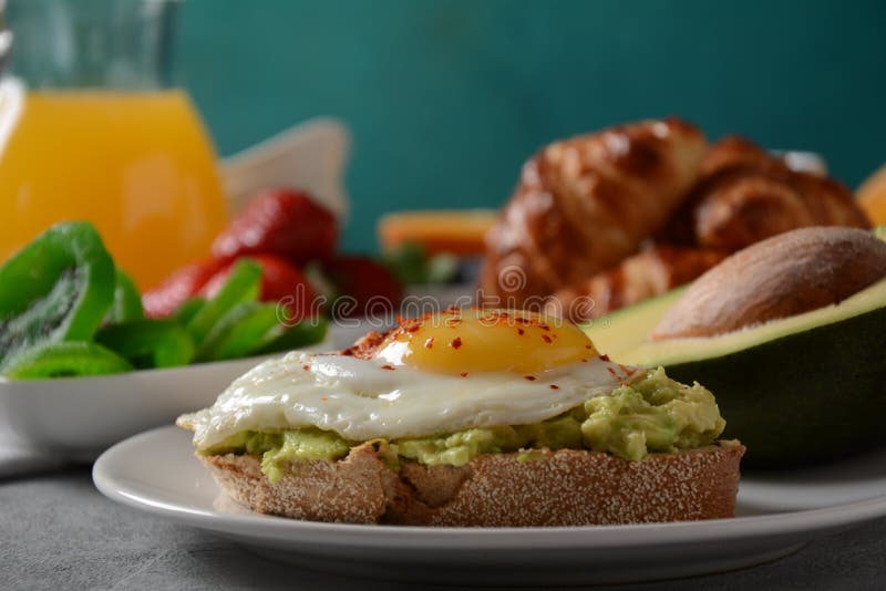 Healthy Breakfast. Toast Avocado Bacon and Eggs Fruits Fresh Juice