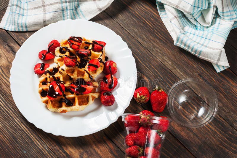 Healthy Breakfast Waffle with Strawberry and Chocolate Syrup on Top