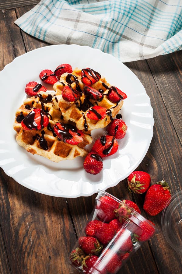 Healthy Breakfast Waffle with Strawberry and Chocolate Syrup on Top