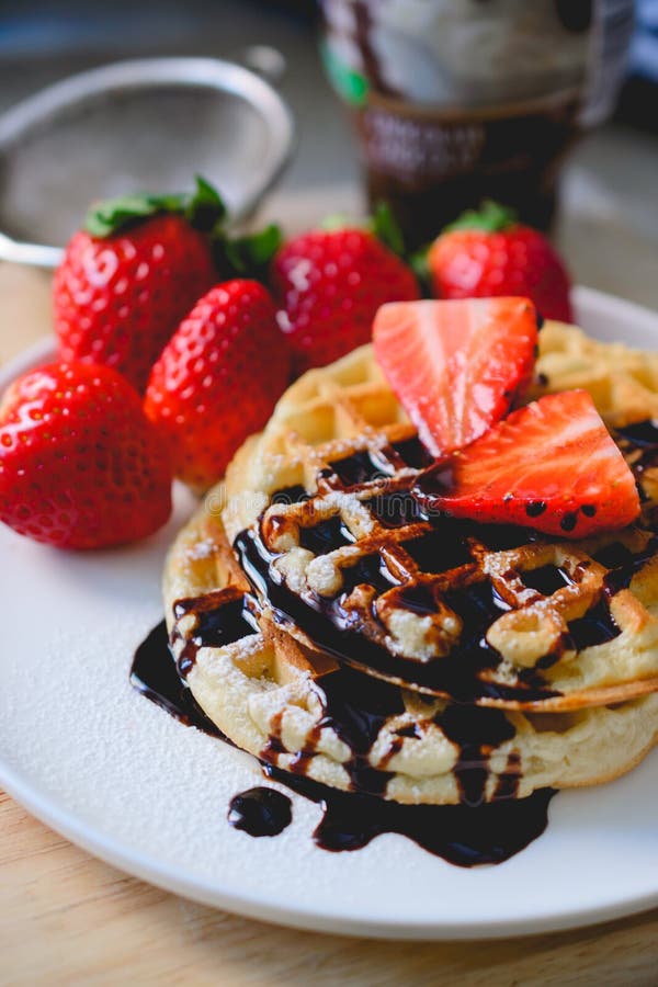 Healthy Breakfast Waffle with Strawberry and Chocolate Syrup on Stock