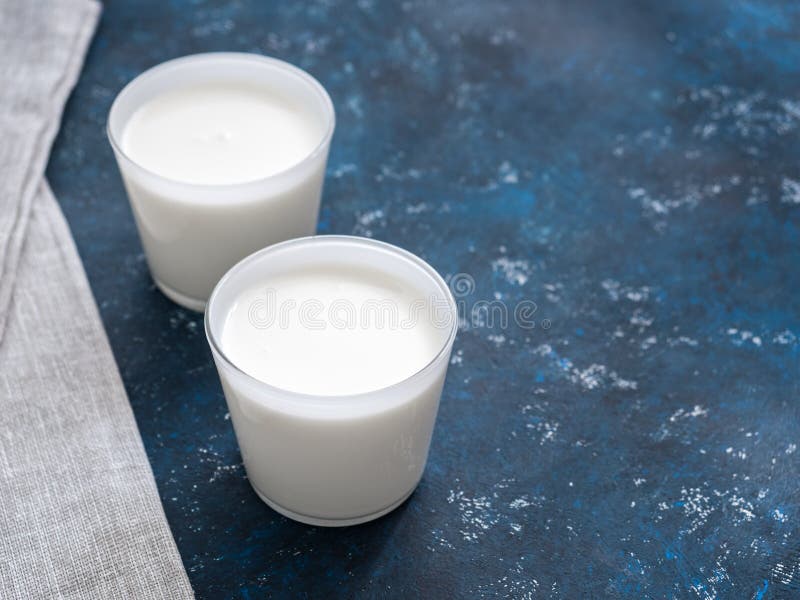 Healthy breakfast. Yogurt in white glasses on a blue background. Copy space stock photos Healthy breakfast. Yogurt in white glasses on a blue background. Copy space stock photos