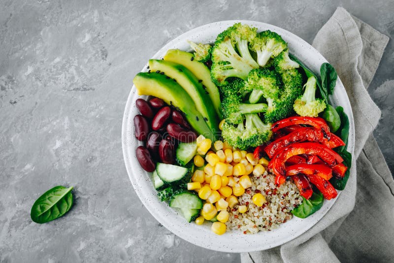Healthy buddha bowl salad with grilled vegetables. Quinoa, spinach, avocado, beans, sweet corn, broccoli, cucumbers and paprika stock photos Healthy buddha bowl salad with grilled vegetables. Quinoa, spinach, avocado, beans, sweet corn, broccoli, cucumbers and paprika stock photos