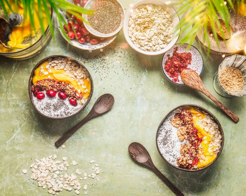 Healthy clean summer breakfast table with smoothie mango bowl and tropical fruits , chia seeds yogurt pudding and cranberries