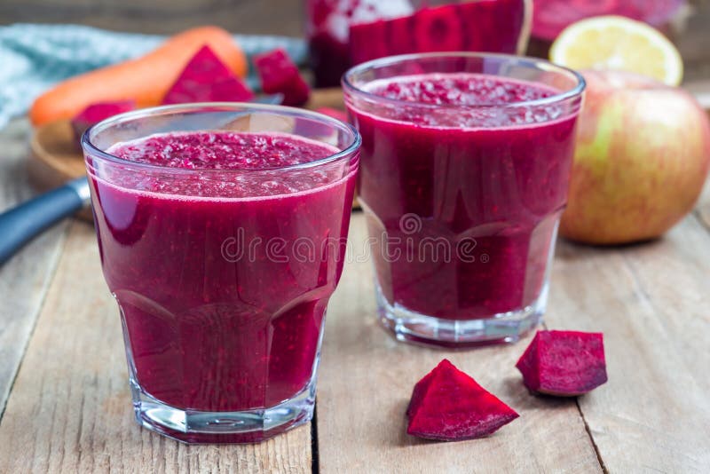 Healthy detox beetroot, carrot, apple and lemon juice smoothie, horizontal. Healthy detox beetroot, carrot, apple and lemon juice smoothie in glass on wooden royalty free stock photo Healthy detox beetroot, carrot, apple and lemon juice smoothie, horizontal. Healthy detox beetroot, carrot, apple and lemon juice smoothie in glass on wooden royalty free stock photo