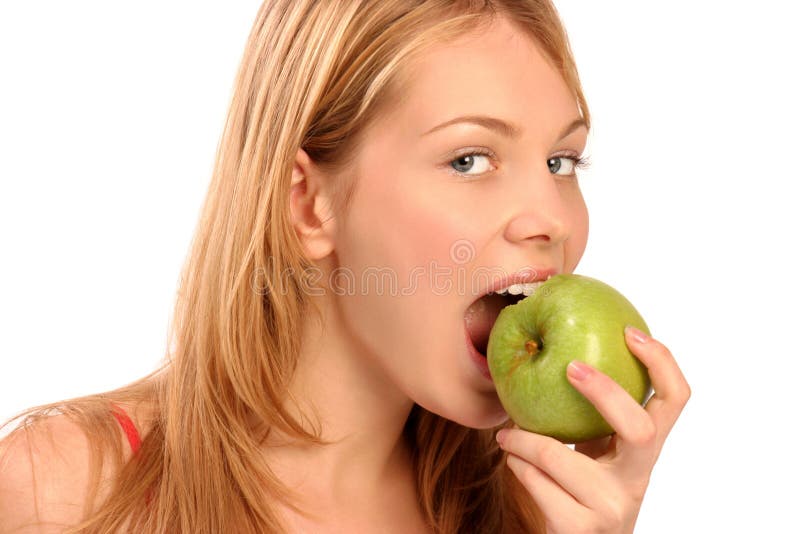 Portrait of a young beautiful girl eating an apple. Portrait of a young beautiful girl eating an apple