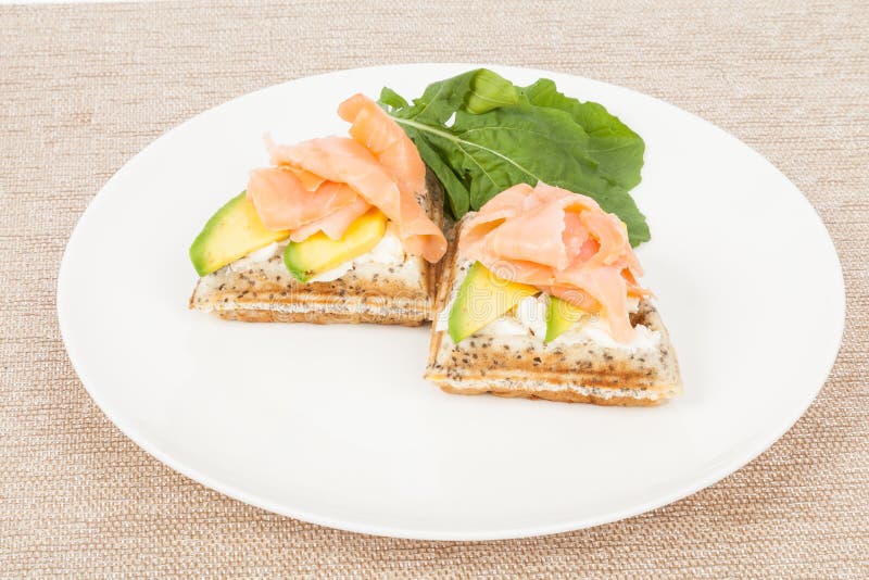 Healthy breakfast waffles with avocado and salmon