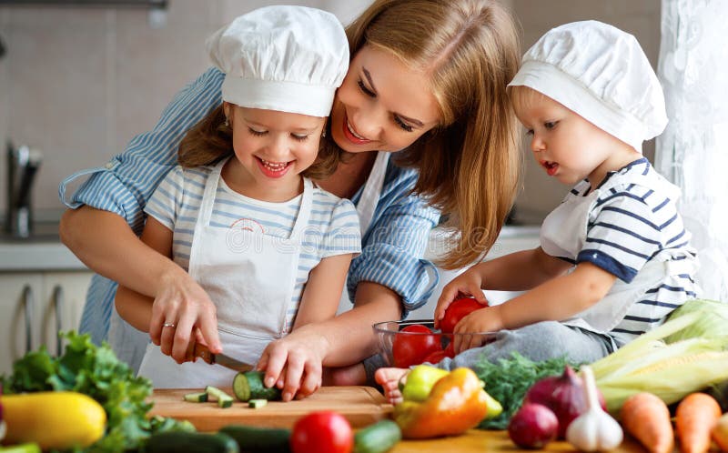 Healthy eating. Happy family mother and children prepares vegetable salad