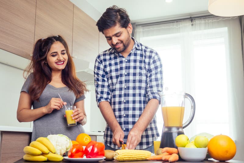 Healthy and Eco Lifestyle.happy Indian Woman with Her Husband Making Smoothie in Big Kitchen Stock Photo - Image of blender, male: 162300540