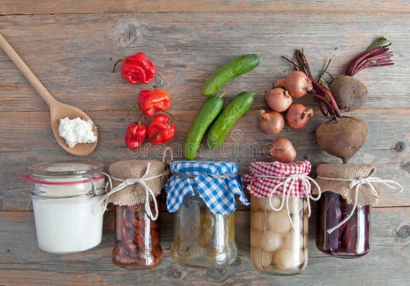 Healthy fermented foods. Naturally fermented foods in jars including kefir, gherkins and peppers and onions stock image