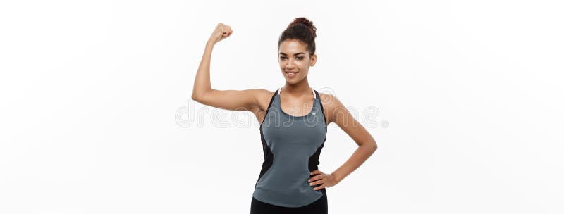 Young beautiful strong woman shows biceps and smiles. Isolated, white  background Stock Photo - Alamy