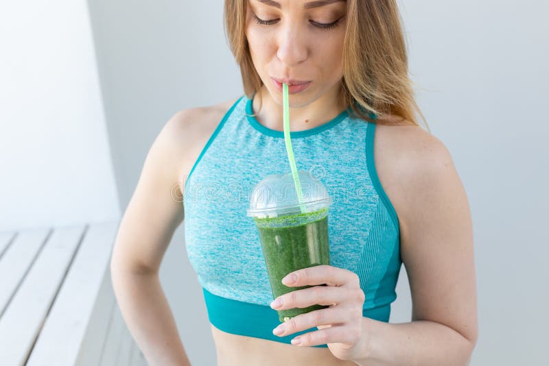 Healthy Fitness And Detox Concept Close Up Of Young Woman In Sports Wear With Green Smoothie 