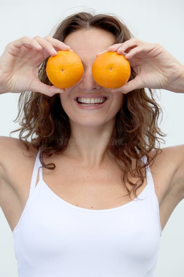 Slim Young Woman Small Boobs Puts Big Orange Fruit In Her Bra. Breast  Enlargement Size Correction Concept. Stock Photo, Picture and Royalty Free  Image. Image 143825659.