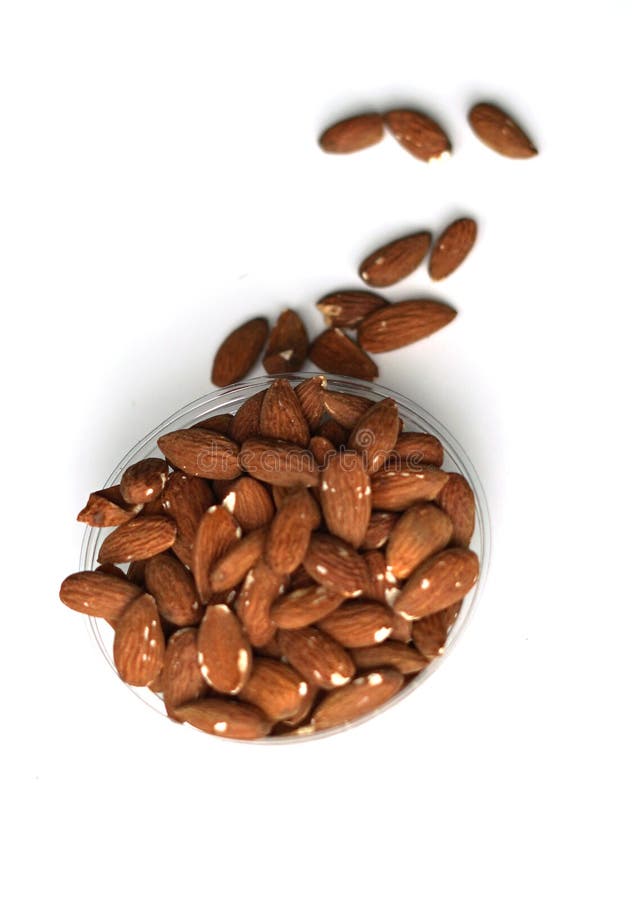 Healthy food for background image close up almond nuts. Texture on white grey table top view. Nuts on the cup plate