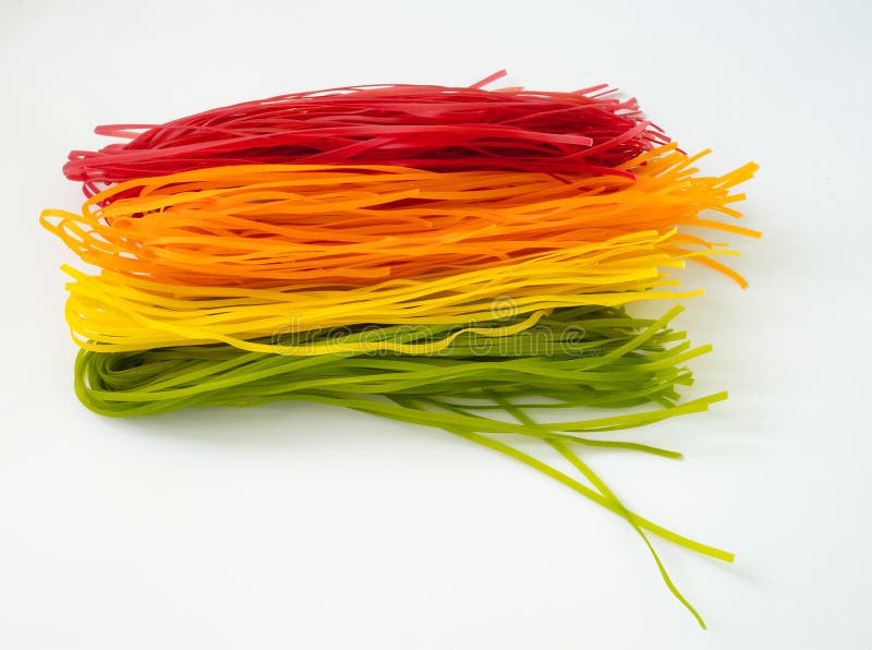 Healthy food concept: different kinds of colorful raw italian pasta and its natural vegetable dyes.