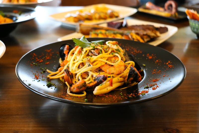 Healthy food concept. Spaghetti with shrimps, prawns and mussels. Blur plates with foods background. stock photos Healthy food concept. Spaghetti with shrimps, prawns and mussels. Blur plates with foods background. stock photos