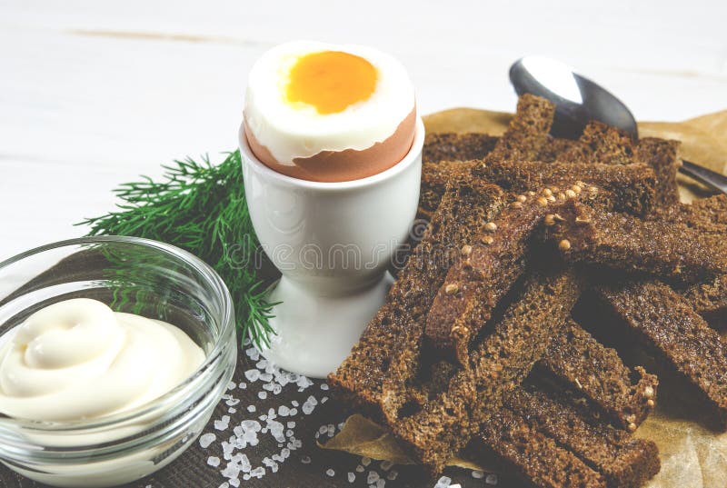 Healthy food. English breakfast with boiled egg and croutons on a white wood background stock images Healthy food. English breakfast with boiled egg and croutons on a white wood background stock images