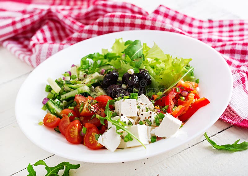 Greek salad of fresh cucumber, tomato, sweet pepper, lettuce, onion, feta cheese