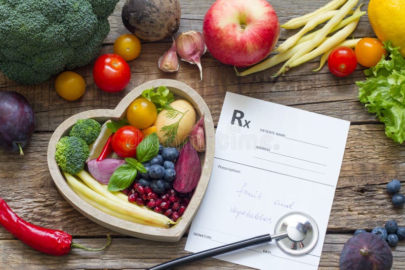 Healthy food in heart stethoscope and medical prescription diet and medicine concept
