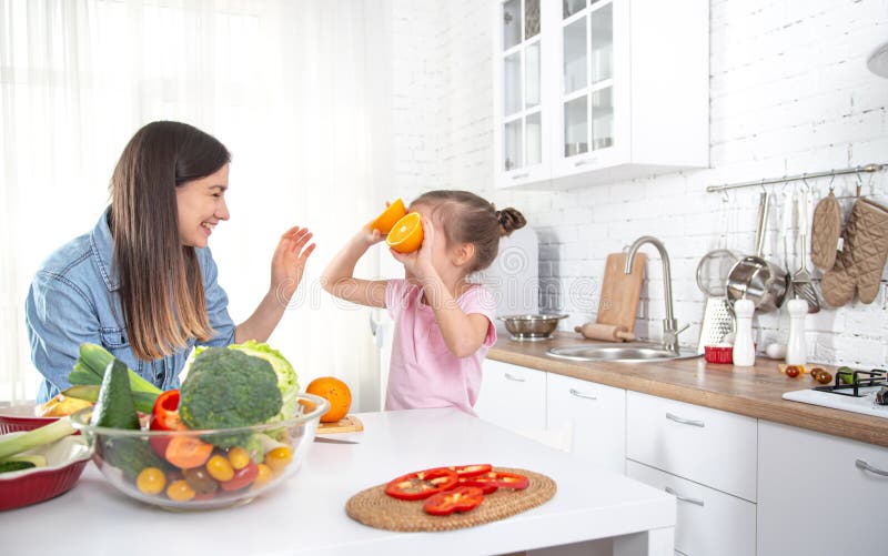 Mom And Daughter In The Kitchen With Fruits And Vegetables Stock Image -  Image of girl, beautiful: 175726497