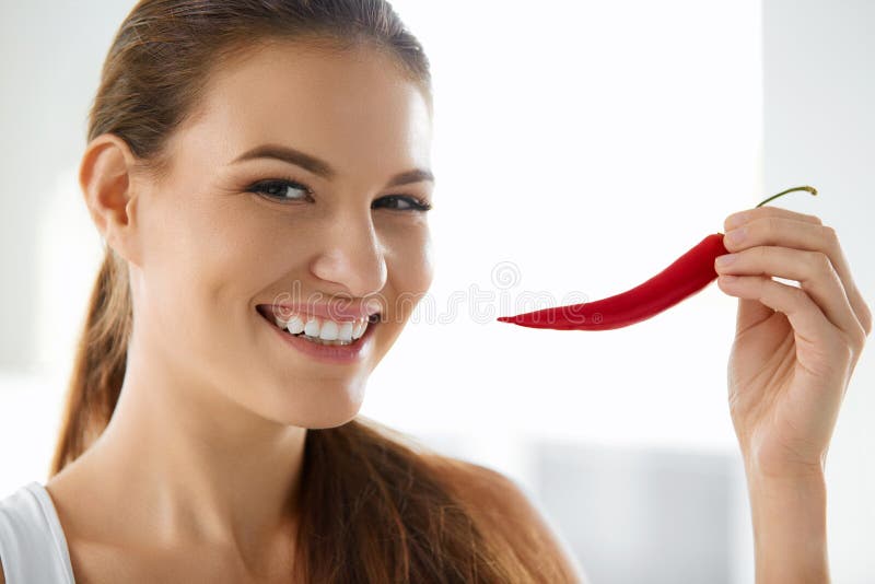 Healthy Food. Smiling Woman Holding Red Chili Pepper. Lifestyle