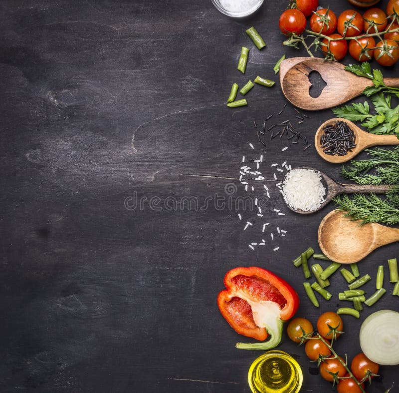 Healthy foods, cooking and vegetarian concept cherry tomatoes, wild rice, spices, salt border ,place for text on wooden rustic background top view close up. Healthy foods, cooking and vegetarian concept cherry tomatoes, wild rice, spices, salt border ,place for text on wooden rustic background top view close up