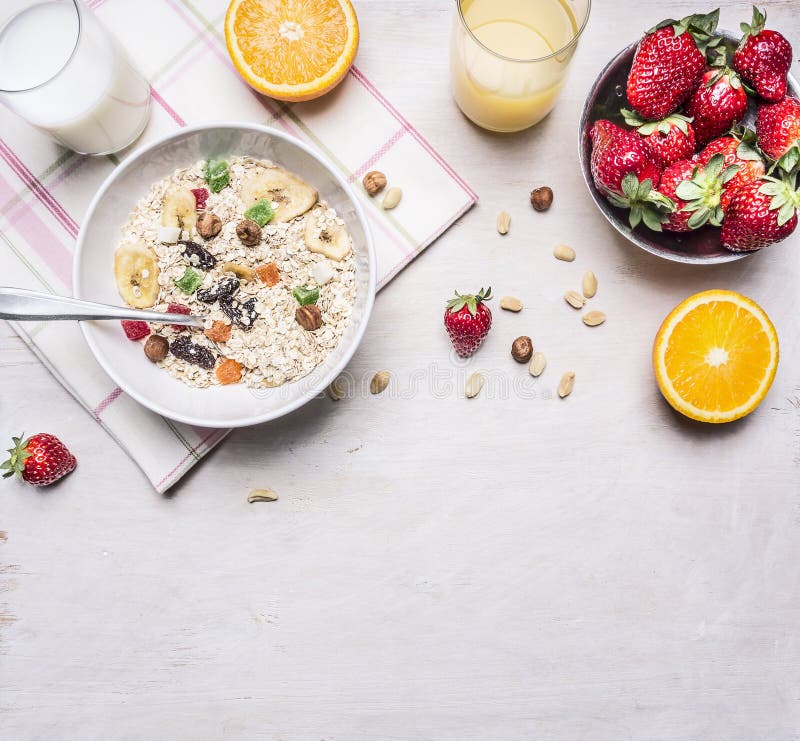Healthy foods, vegetarian concept hazelnuts, strawberries and oranges, oatmeal, milk juice border ,place for text on wooden stock photos Healthy foods, vegetarian concept hazelnuts, strawberries and oranges, oatmeal, milk juice border ,place for text on wooden stock photos