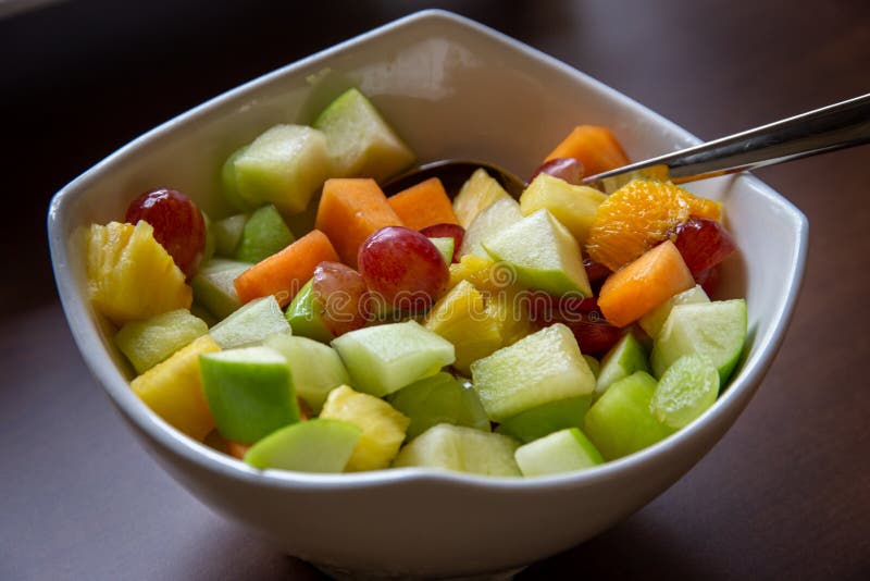 Healthy fresh fruit salad in a white bowl