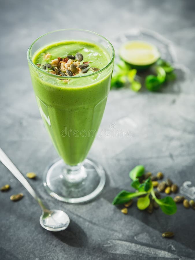 Healthy green smoothie with spinach, banana and pumpkin seeds. royalty free stock photo Healthy green smoothie with spinach, banana and pumpkin seeds. royalty free stock photo