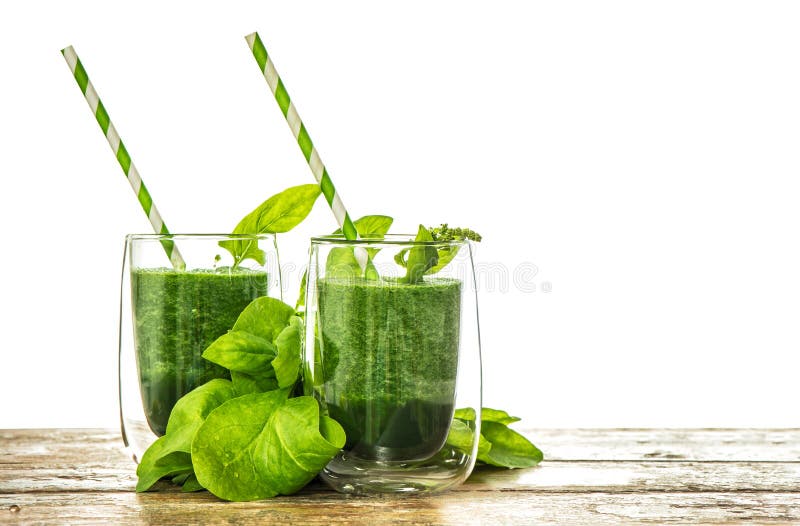 Healthy green spinach leaves smoothie in transparent glass royalty free stock photo Healthy green spinach leaves smoothie in transparent glass royalty free stock photo