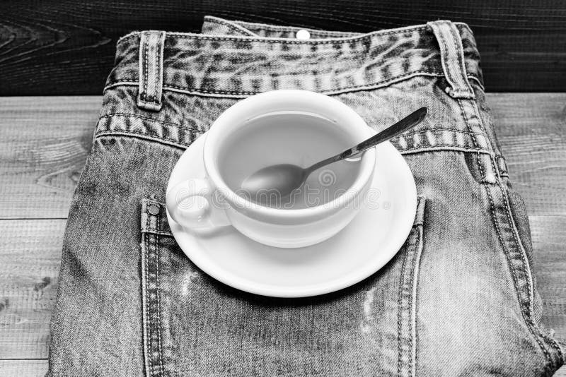 Healthy habits. Tea time concept. Cup mug hot water and bag of tea. Mug filled boiling water and tea bag on blue jeans