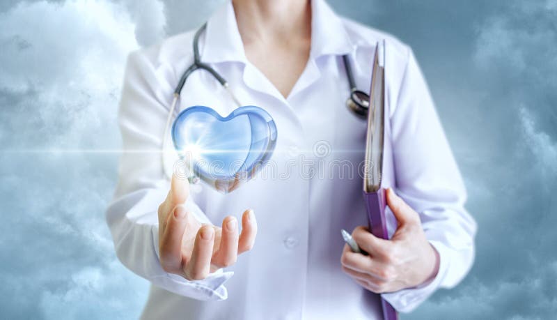 Healthy heart in the hand of the cardiologist.