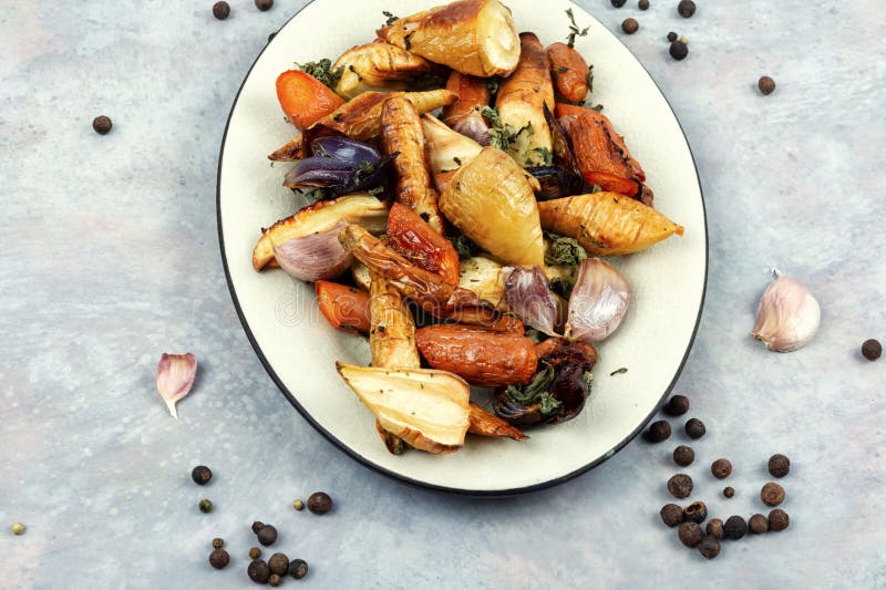 Baked sliced parsnip root and carrots stock images