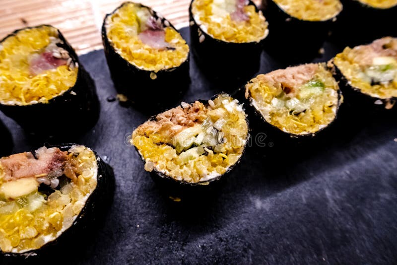 Healthy homemade sushi rolls with brown rice, fish and green vegetable rolls. stock photos Healthy homemade sushi rolls with brown rice, fish and green vegetable rolls. stock photos