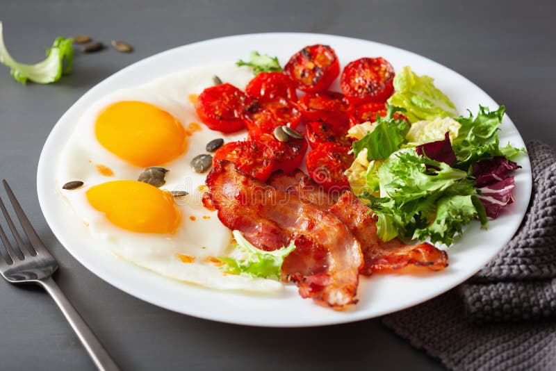 Healthy Keto Diet Breakfast Egg, Tomatoes, Salad Leaves and Bacon