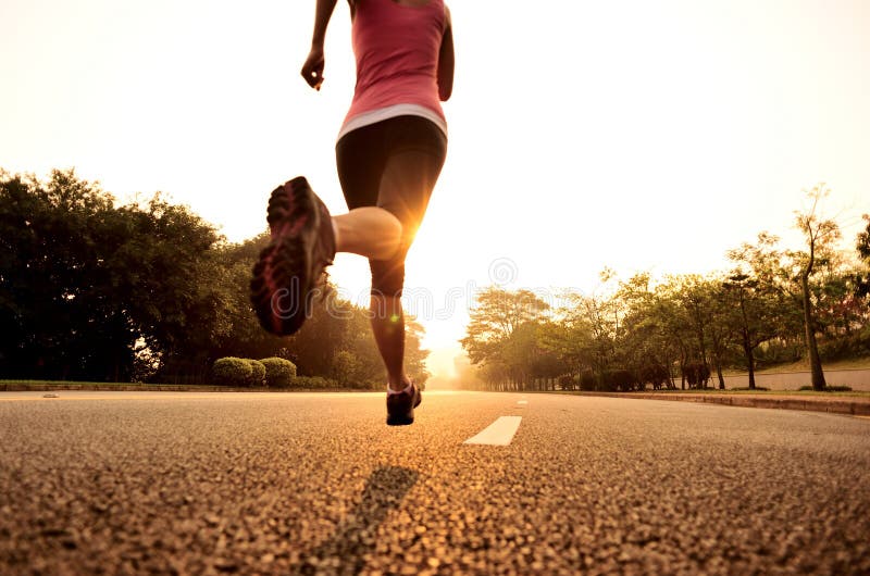 Young woman running in the nature. Healthy lifestyle and sport concepts.  Runner training in a urban area.The woman with runner on the street be  running for exercise. Stock Photo