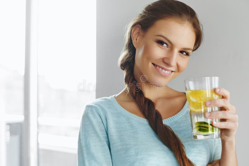 Healthy Lifestyle And Food. Woman Drinking Fruit Water. Detox. H