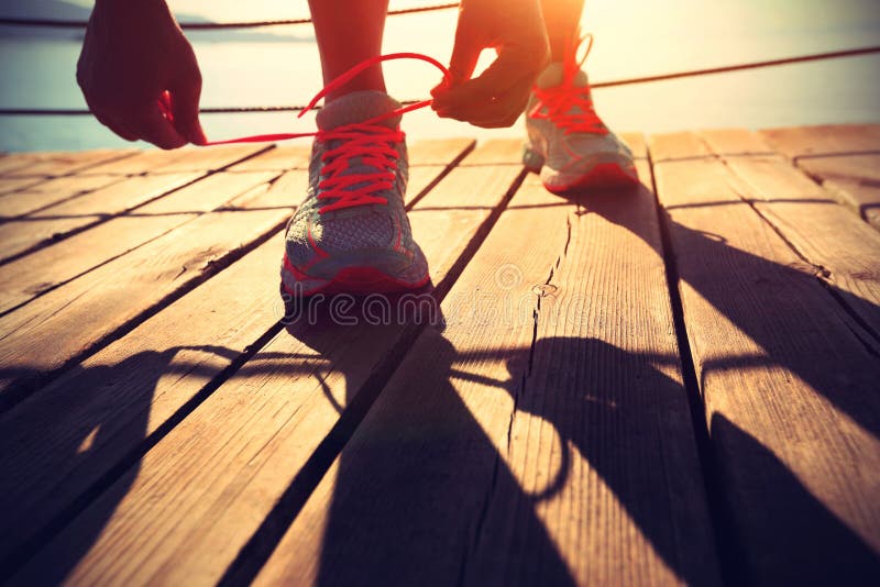 Healthy lifestyle sports woman tying shoelace