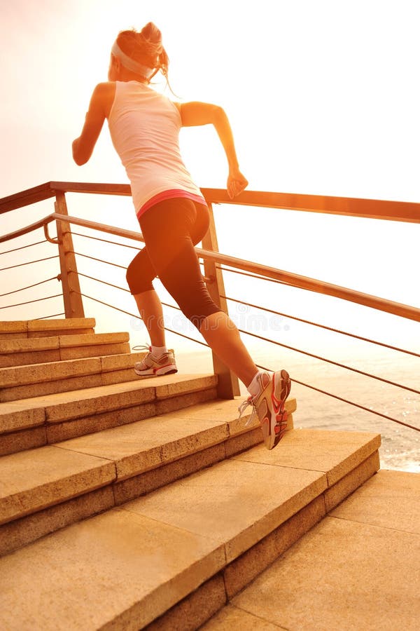 Healthy lifestyle woman running on stone stairs