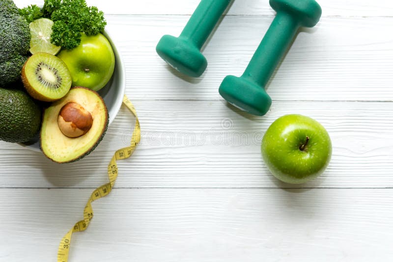 Healthy lifestyle for women diet with dumbbells sport equipment, sneakers, measuring tape, fruit healthy green apples and bottle o royalty free stock images Healthy lifestyle for women diet with dumbbells sport equipment, sneakers, measuring tape, fruit healthy green apples and bottle o royalty free stock images