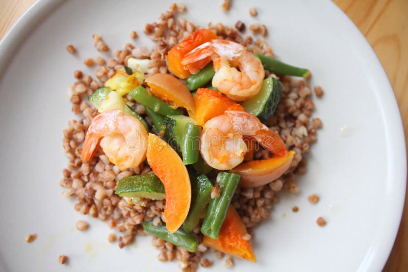 Healthy meal - buckwheat with shrimps, green beans, pumpkin and zucchini