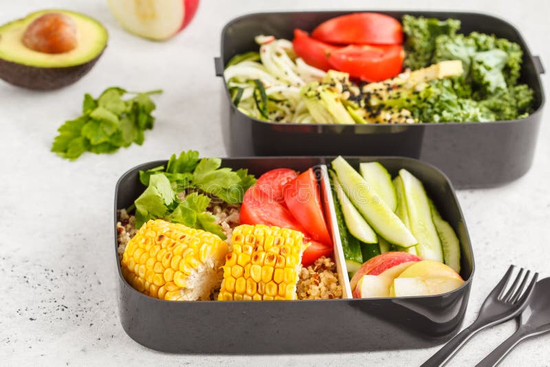 Healthy meal prep containers with quinoa, avocado, corn, zucchini noodles and kale. Takeaway food.